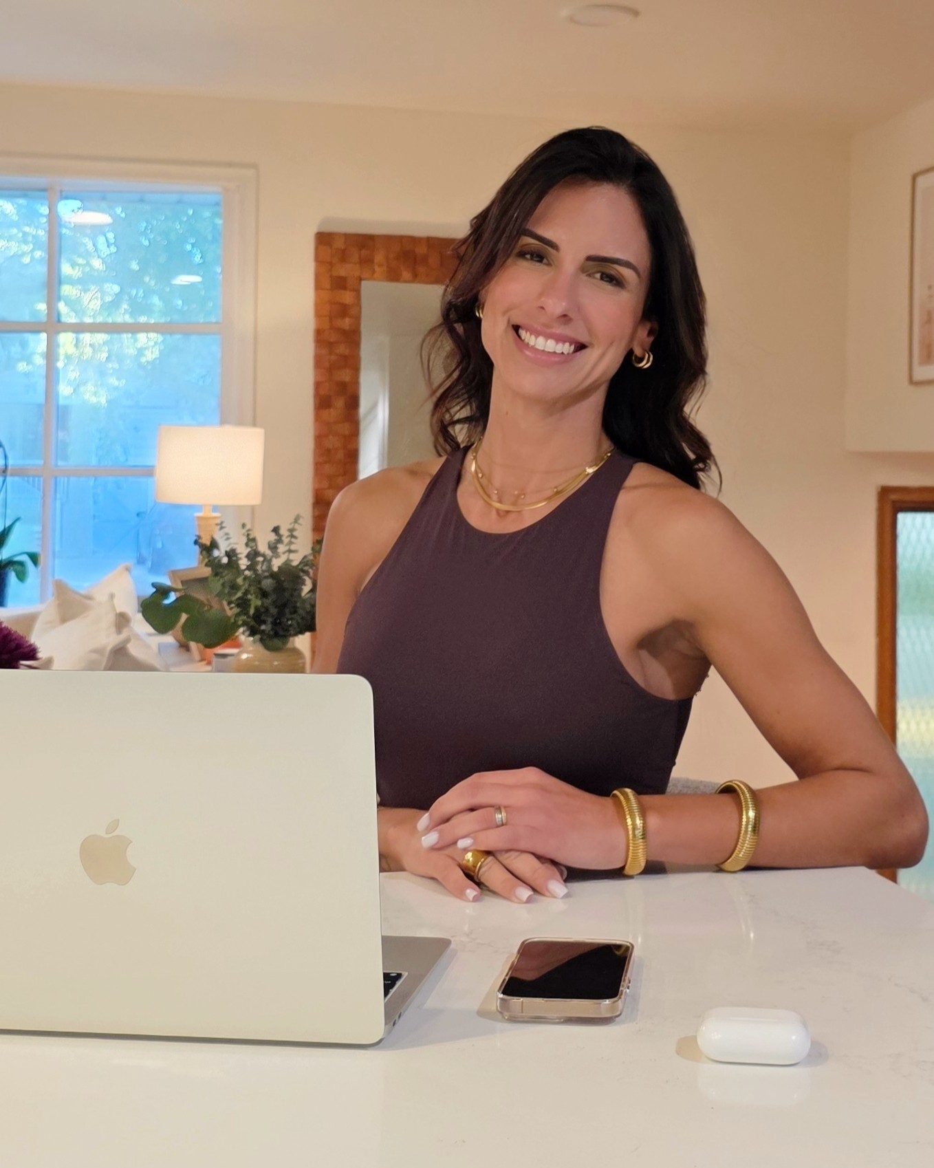 Jessica Souza, founder of Spaces of Eos, in a bright home interior